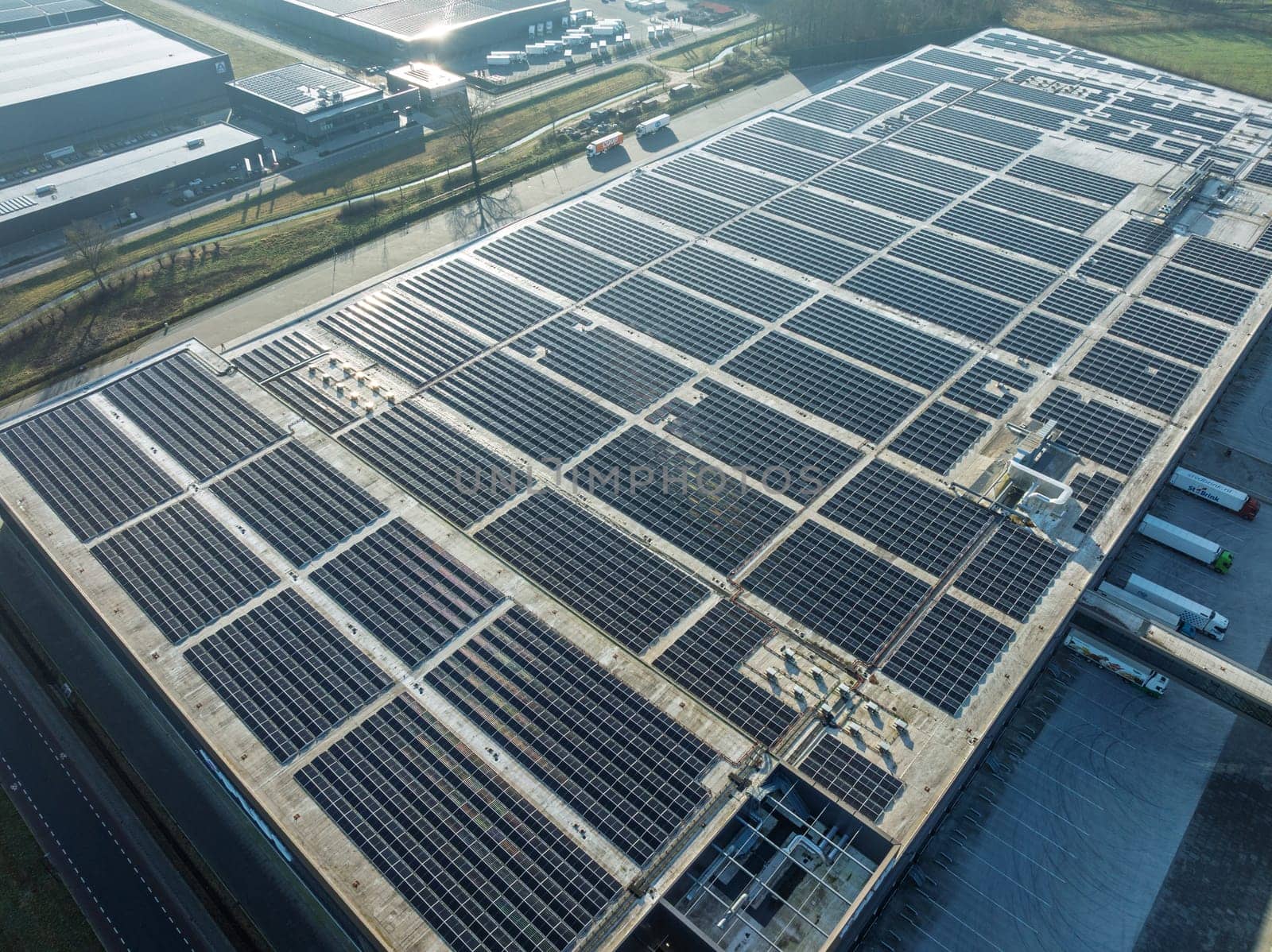 aerial view of a warehouse roof filled with solar panels