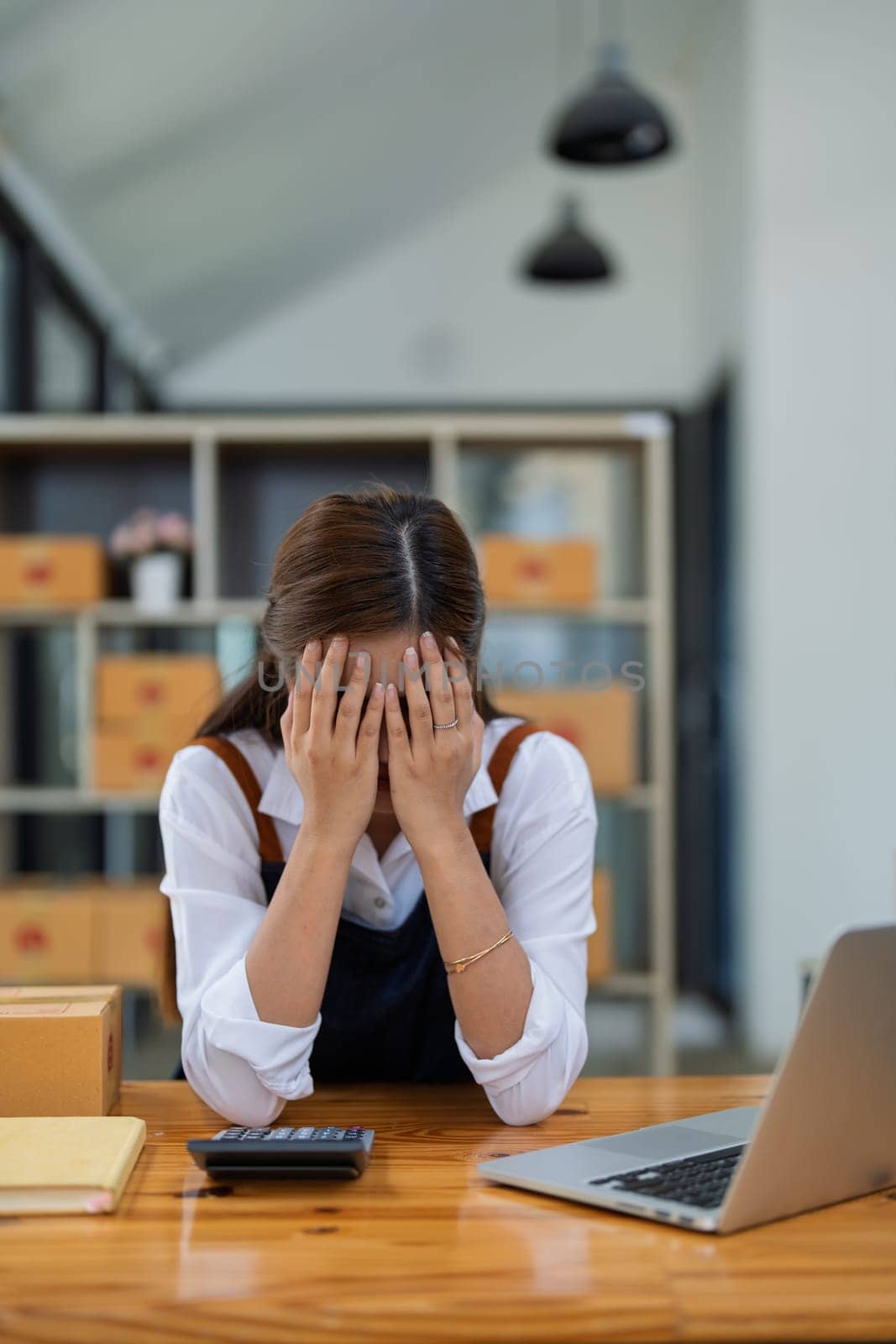 Young woman engaged in online business with stress thoughtful within data products Sales did not meet target Selling products of This month.