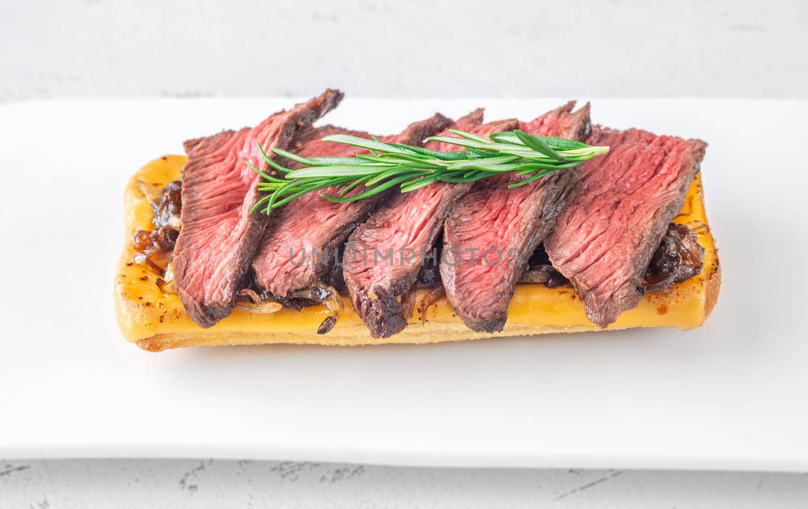 Crispy ciabatta filled with melted cheese, tender steak, sweet onions, and fresh rosemary