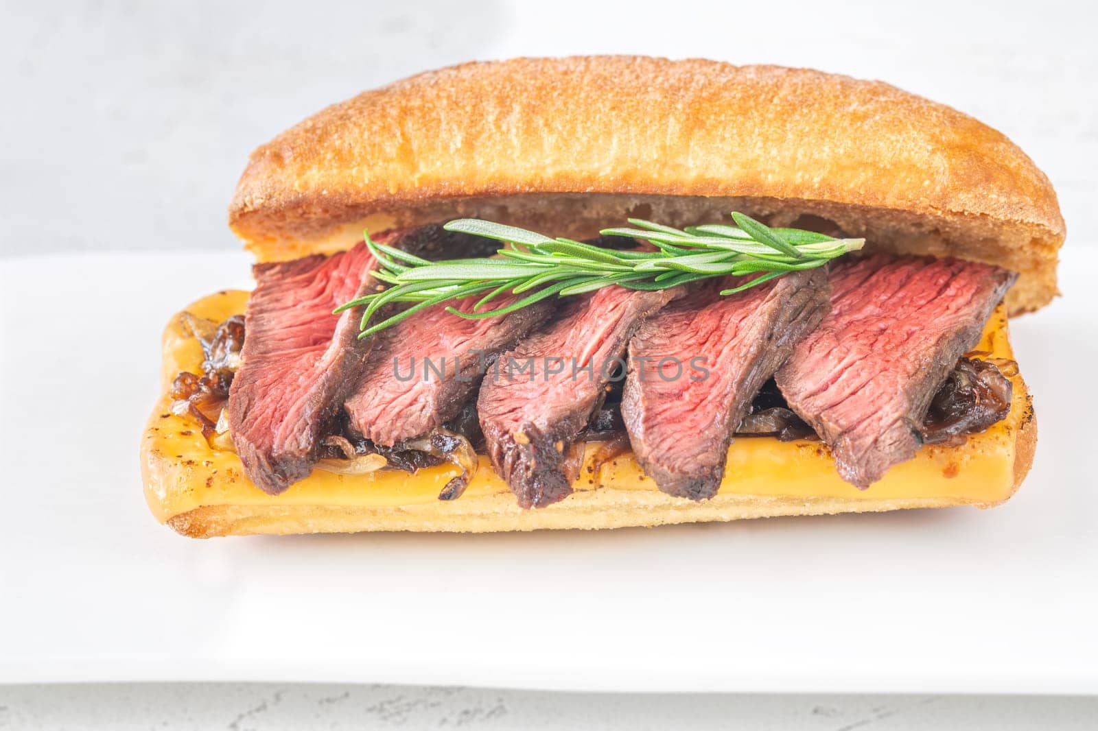 Crispy ciabatta filled with melted cheese, tender steak, sweet onions, and fresh rosemary