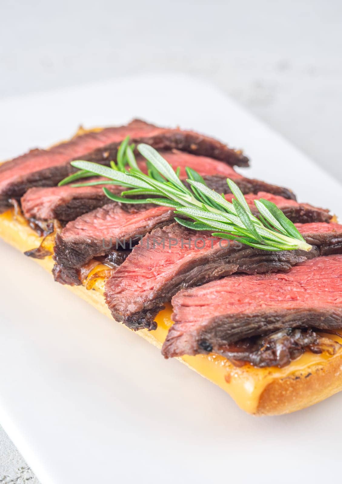 Crispy ciabatta filled with melted cheese, tender steak, sweet onions, and fresh rosemary