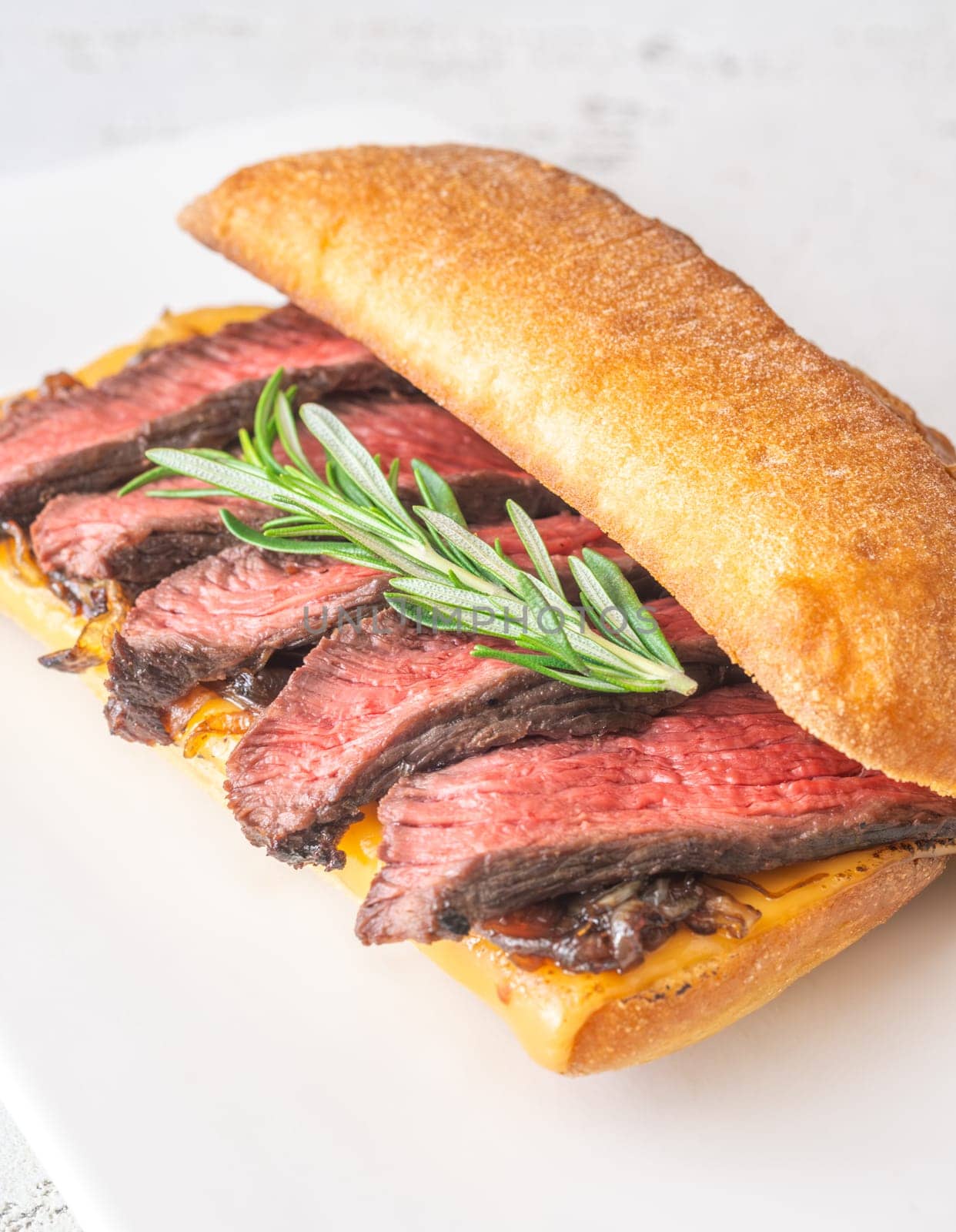 Crispy ciabatta filled with melted cheese, tender steak, sweet onions, and fresh rosemary