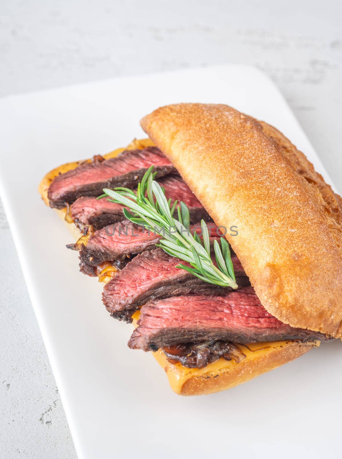Crispy ciabatta filled with melted cheese, tender steak, sweet onions, and fresh rosemary