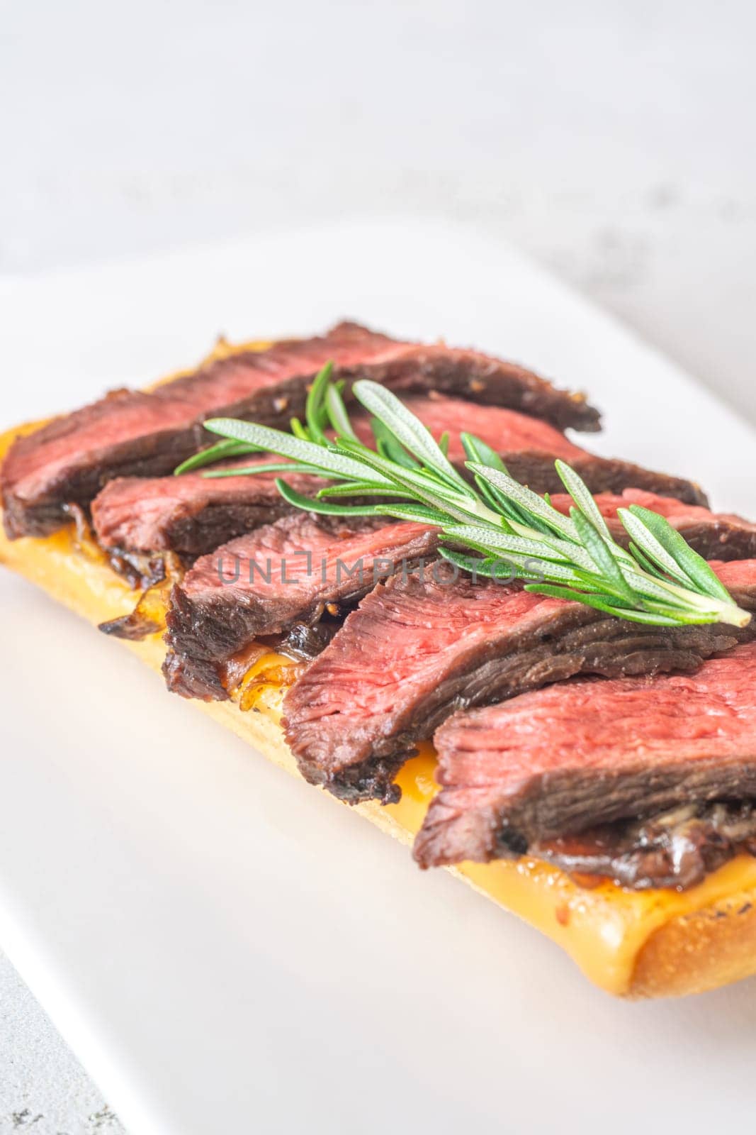 Crispy ciabatta filled with melted cheese, tender steak, sweet onions, and fresh rosemary