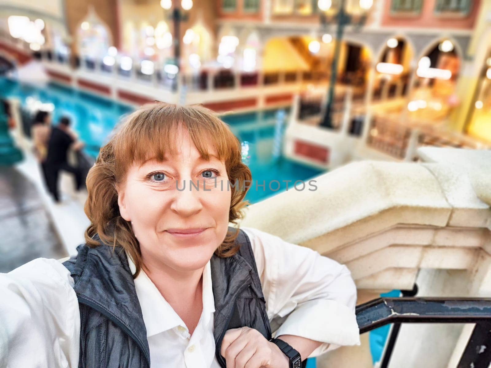 A visitor enjoys the vibrant atmosphere of Macau's famous casinos, surrounded by games and entertainment options.