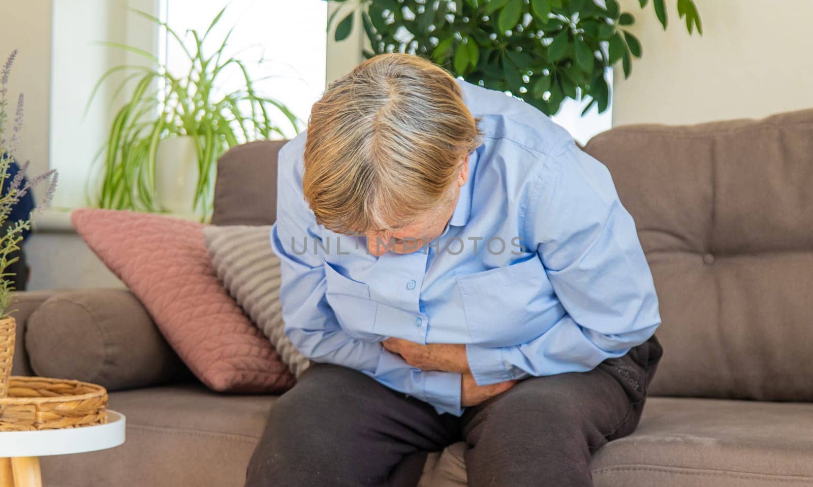 Old woman has stomach ache. Selective focus. people,