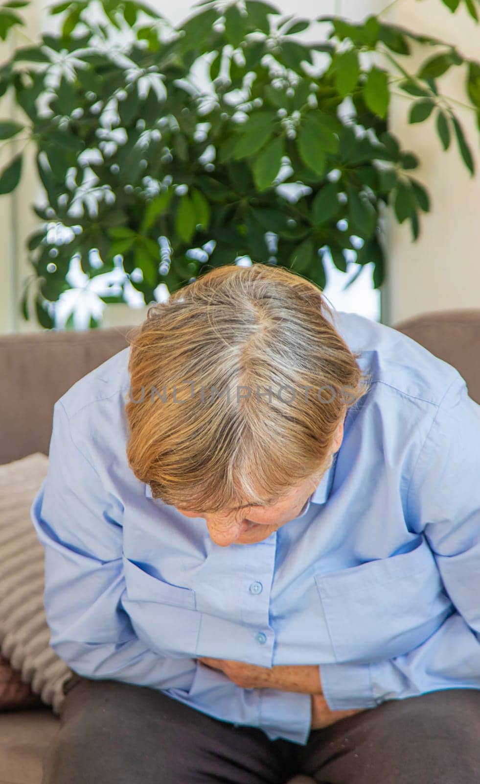 Old woman has stomach ache. Selective focus. people,