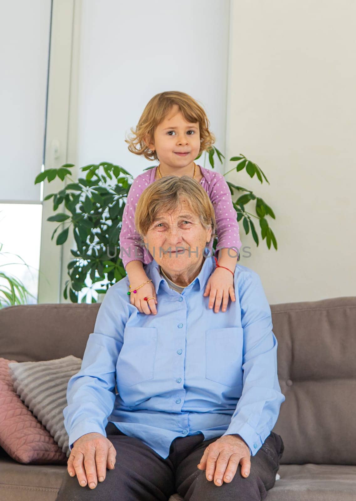 Old woman with her granddaughter. Selective focus. People,