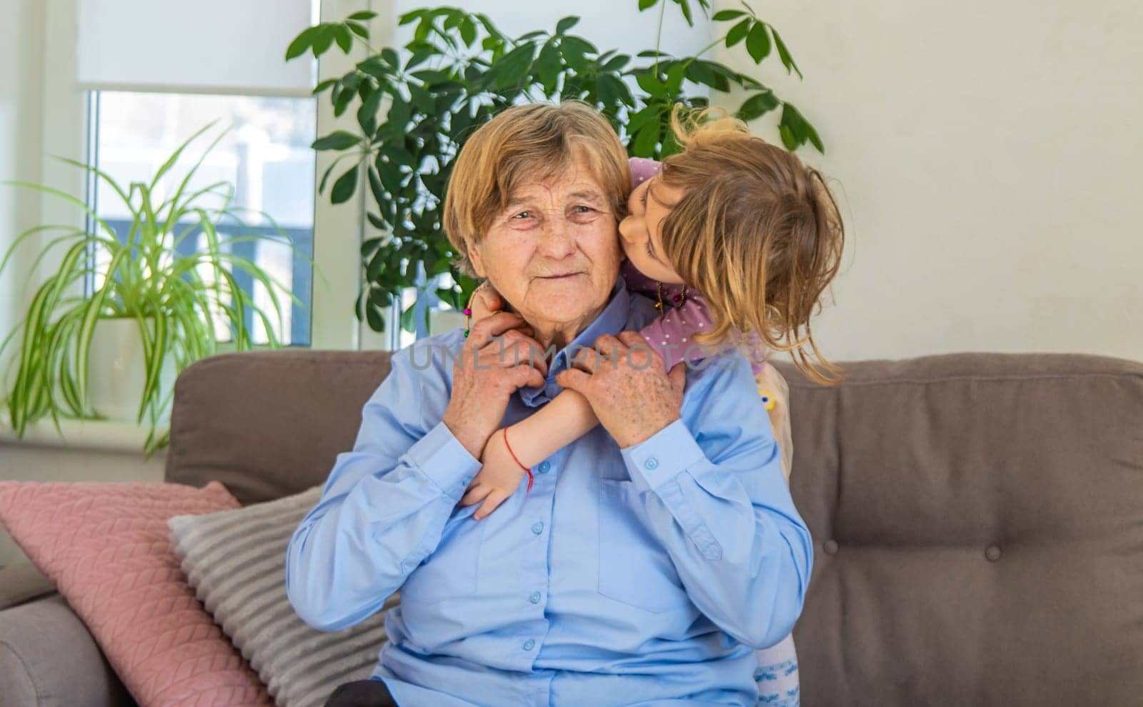 Old woman with her granddaughter. Selective focus. People,