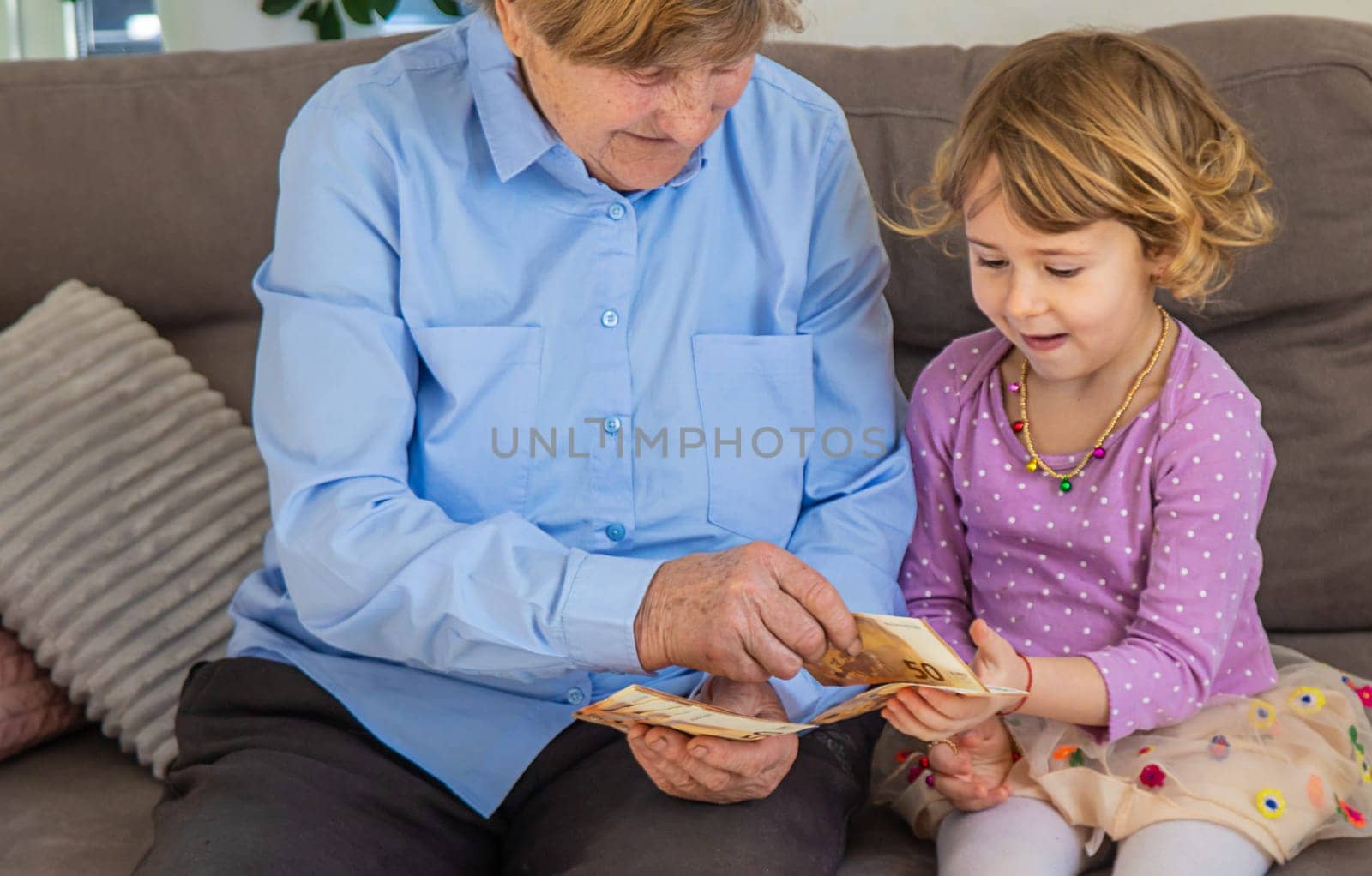 Old woman with her granddaughter. Selective focus. People,