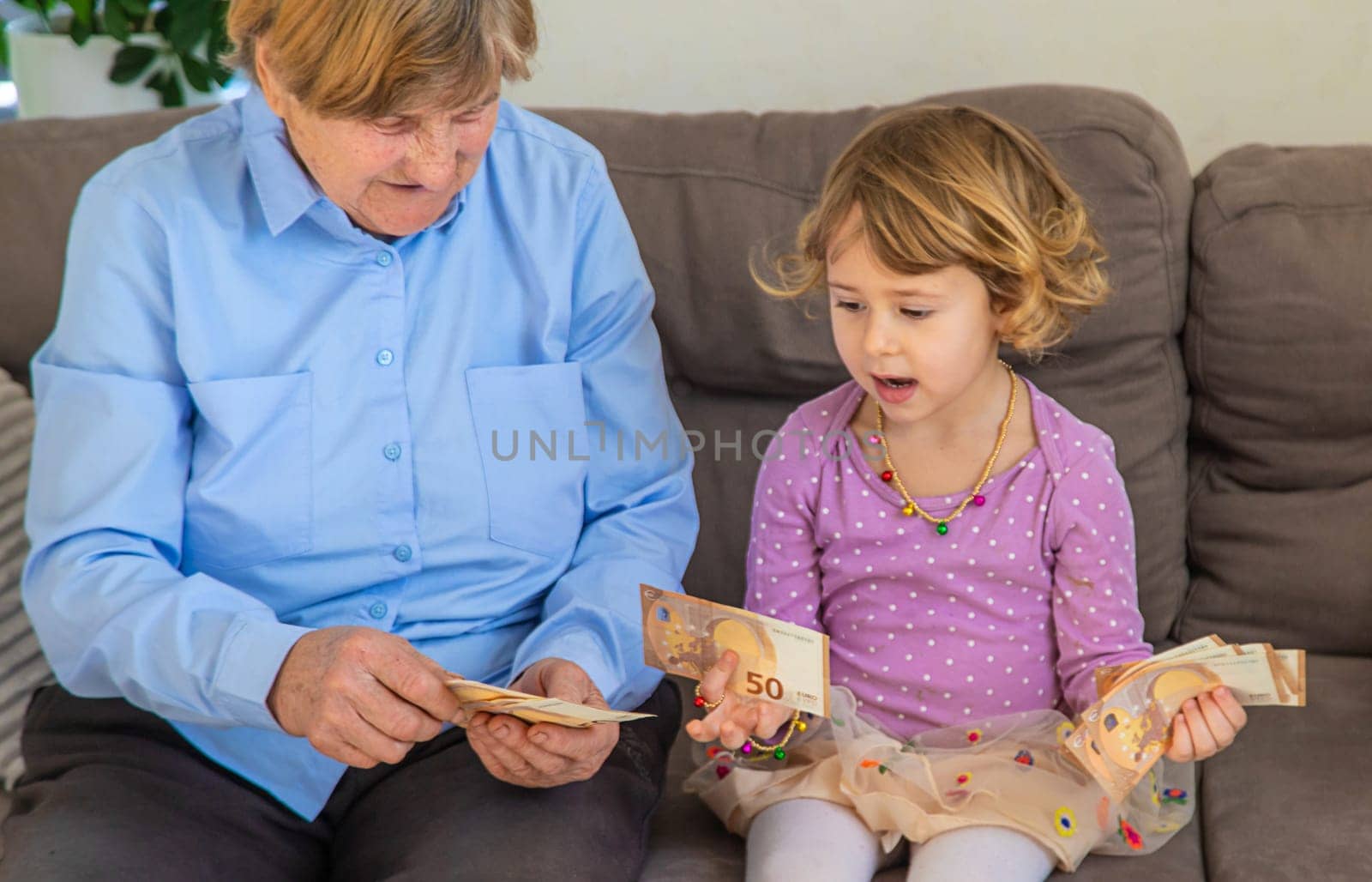 Old woman with her granddaughter. Selective focus. People,