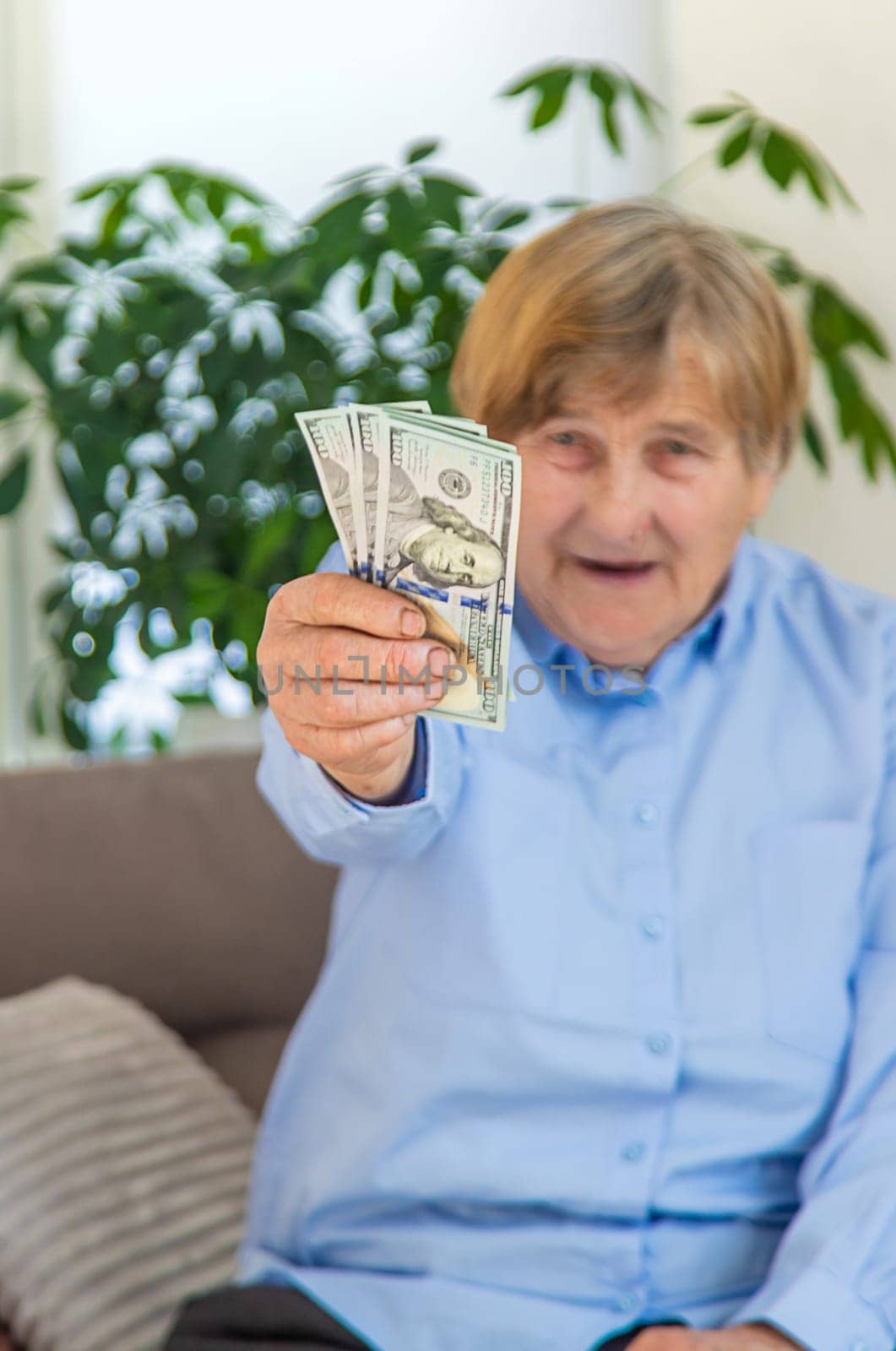 Old woman with money. Selective focus. People,