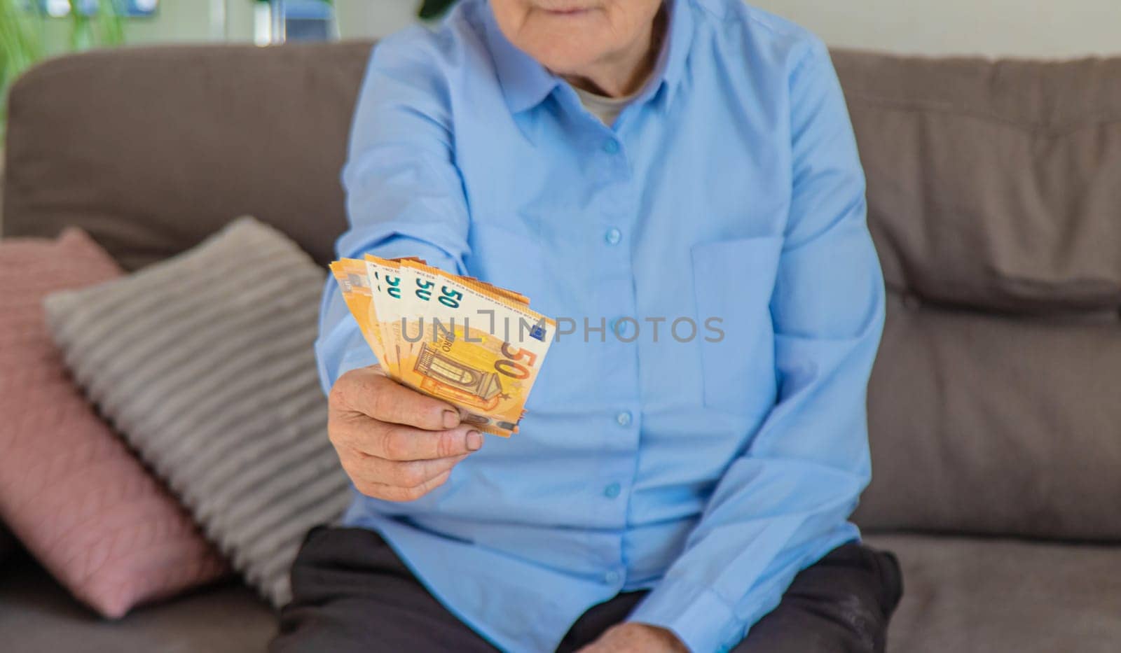 Old woman with money. Selective focus. People,