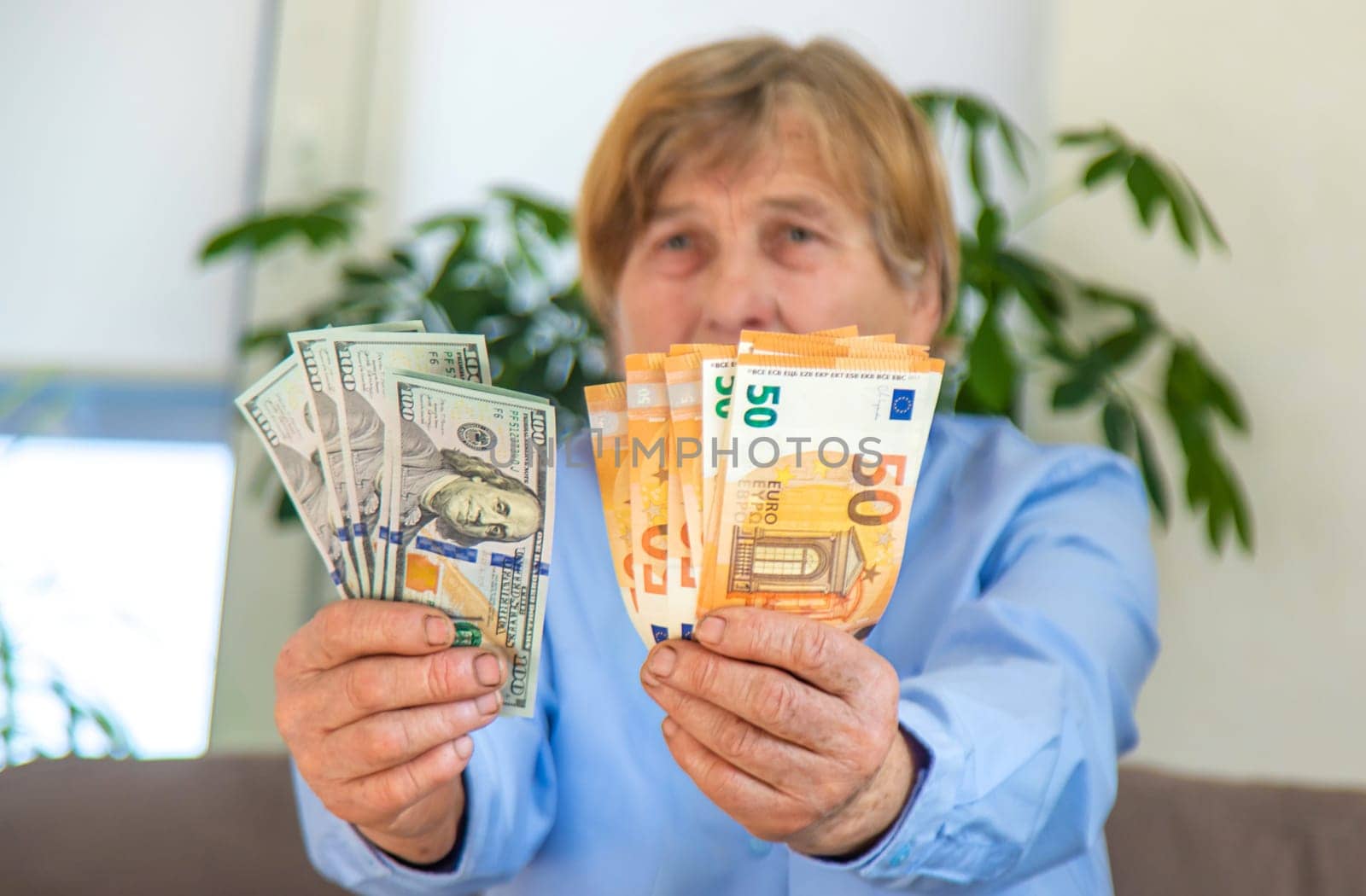Old woman with money. Selective focus. People,