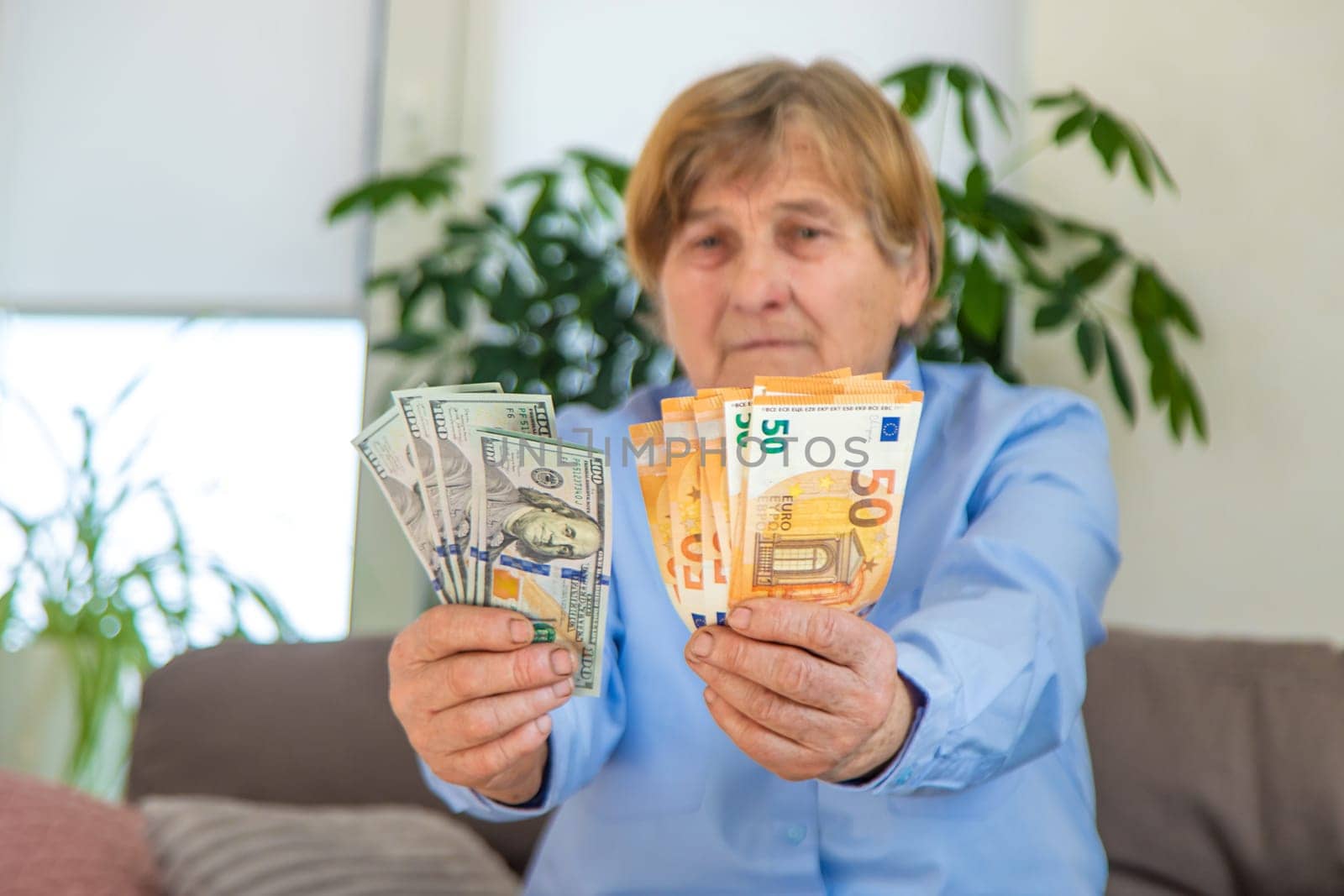 Old woman with money. Selective focus. People,