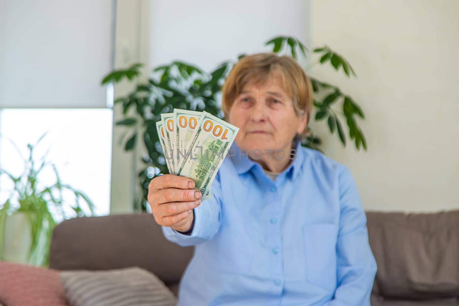Old woman with money. Selective focus. People,