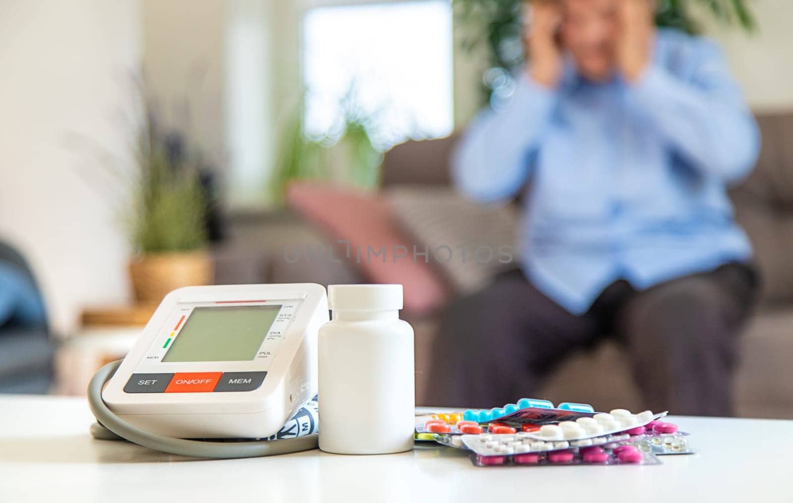 An old woman measures her blood pressure. Selective focus. people,