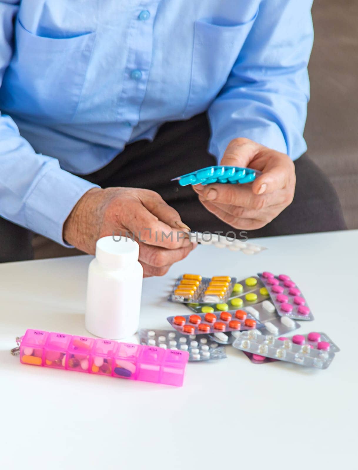 Old woman with medicine. Selective focus. people,