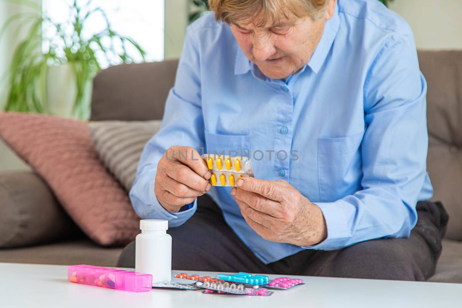 Old woman with medicine. Selective focus. people,