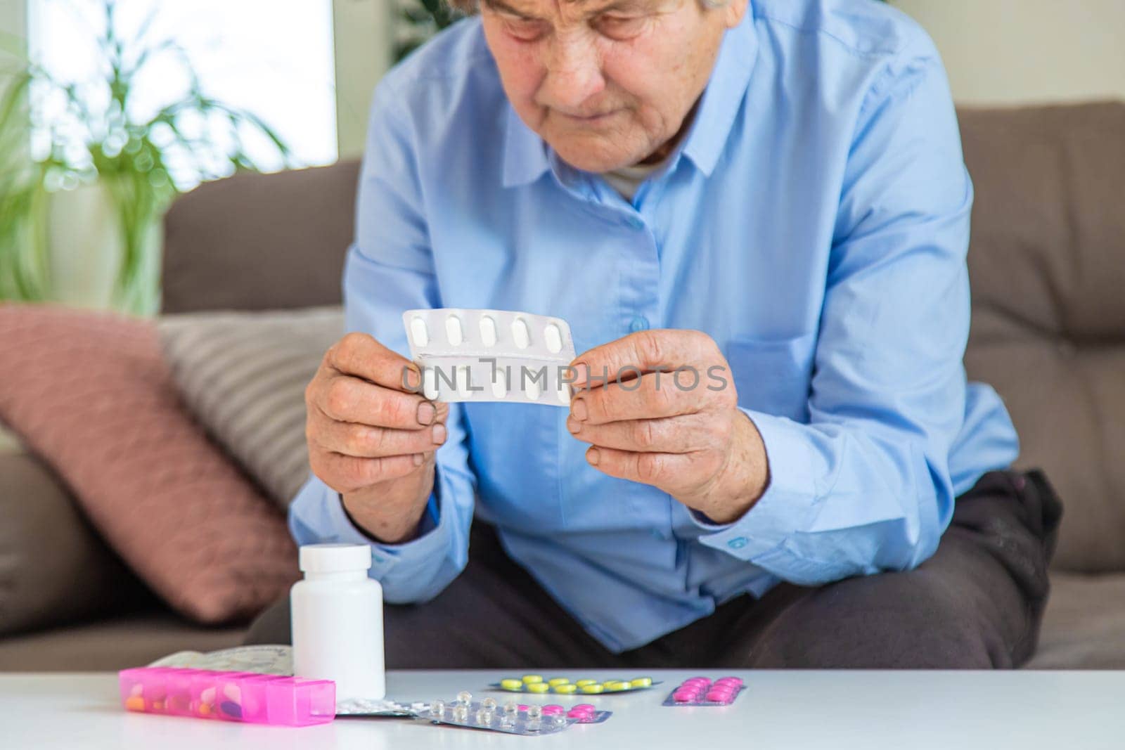 Old woman with medicine. Selective focus. people,