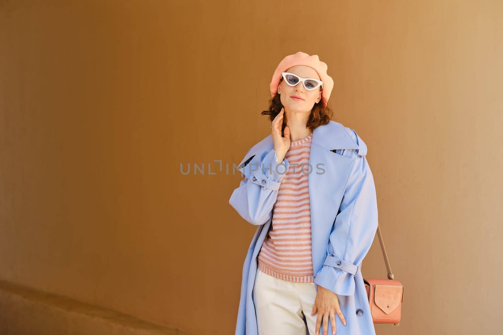 Cheerful positive woman in stylish colorful outfit posing outdoor