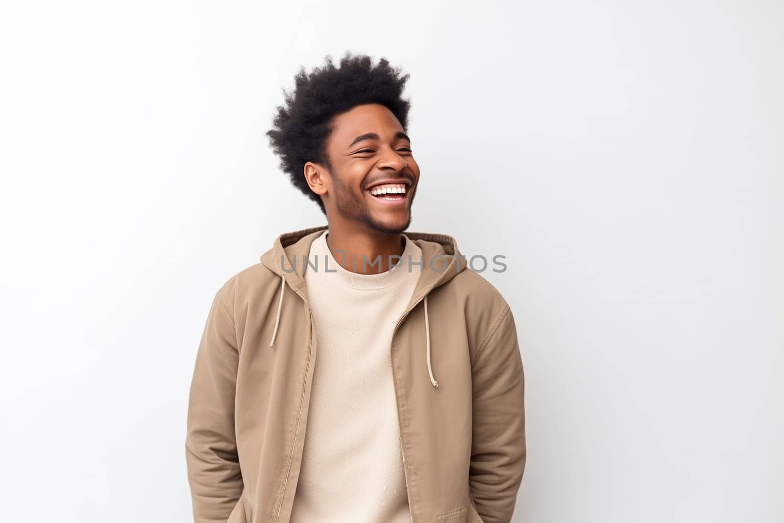 Portrait of happy modern young black American man laughing isolated on white background, African male student looking away, studio shot