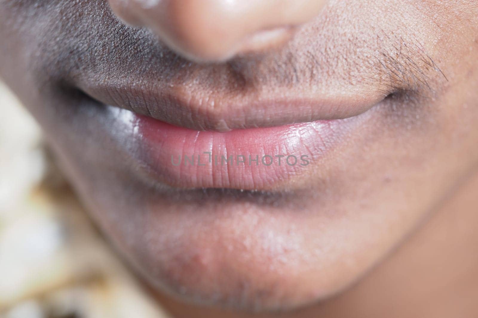 Lips of a young individual are showcased, emphasizing details and texture.