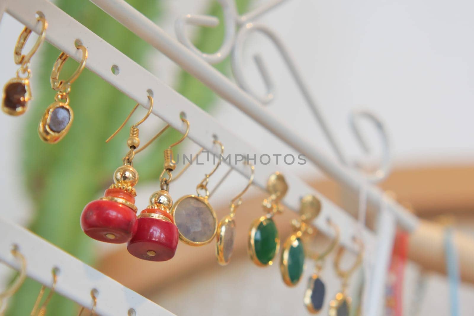A collection of colorful earrings is arranged on a stylish display rack.