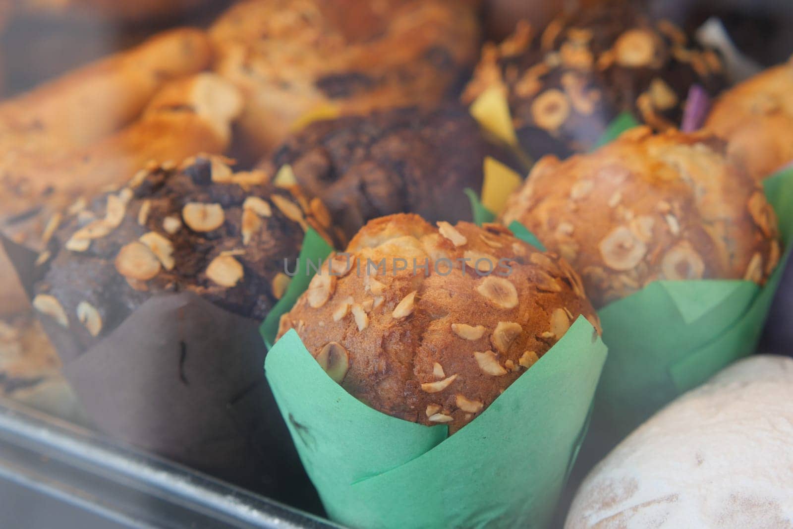 Colorful muffins topped with oats attract customers at the bakery.