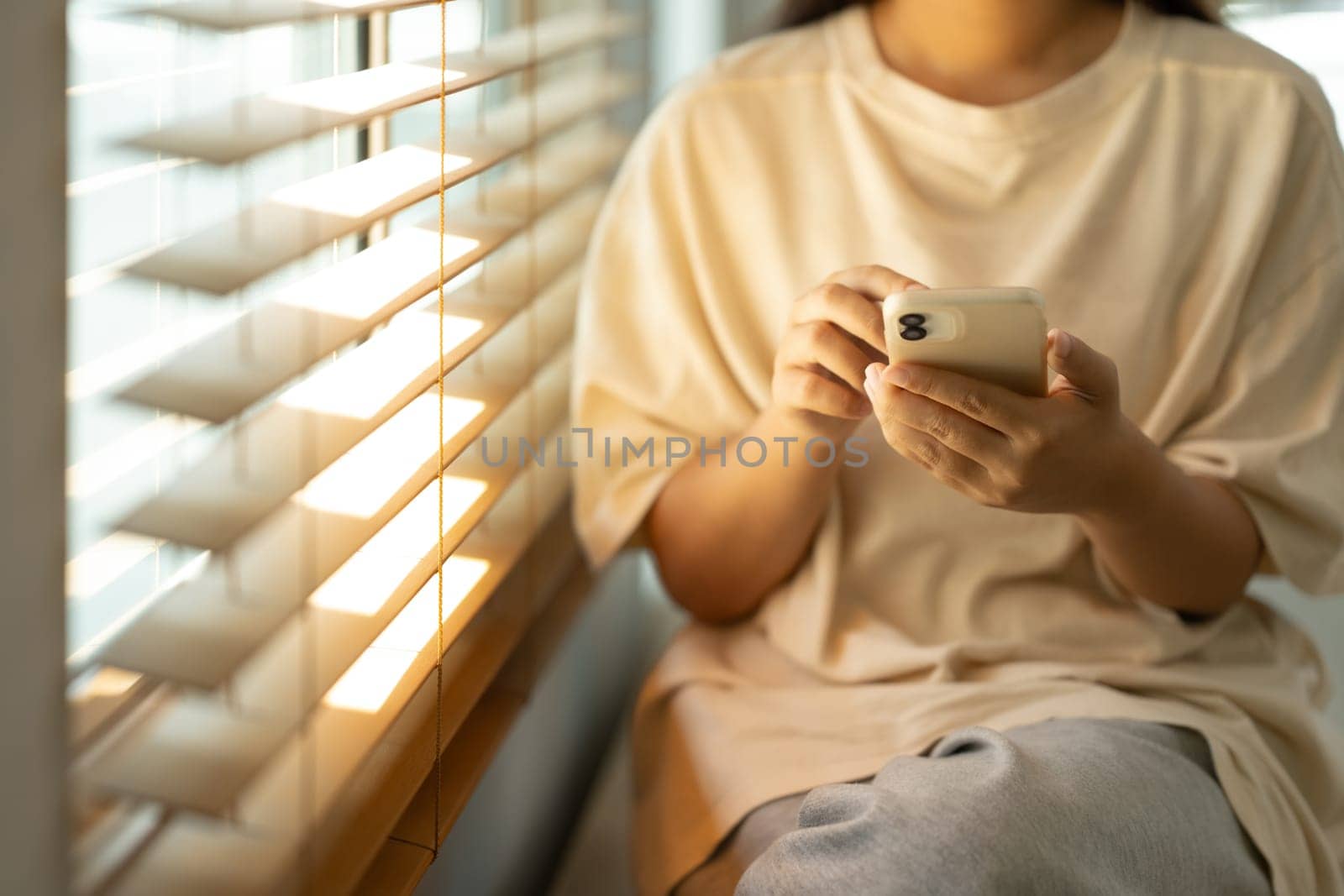 Young woman checking messages or browsing social media on her smartphone.