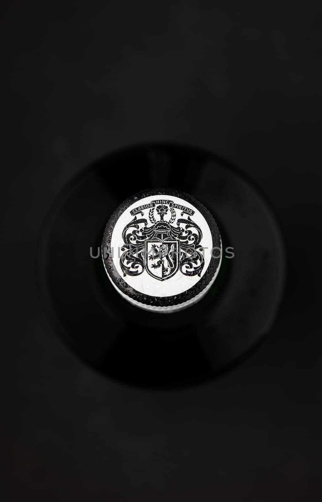 Gaziveren Cyprus -12.03.2025 Black & White whisky A detailed seal rests against a black backdrop, highlighting its ornate design and textured surface.