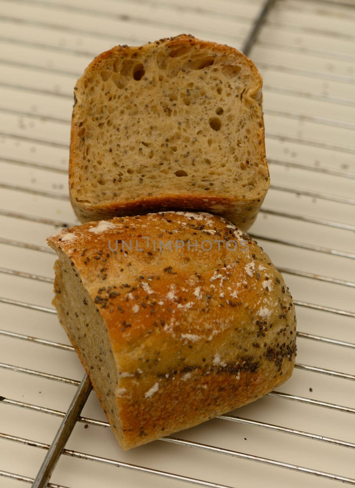 Freshly baked sourdough bread showcases a golden crust and a soft, airy crumb, resting on a cooling rack.