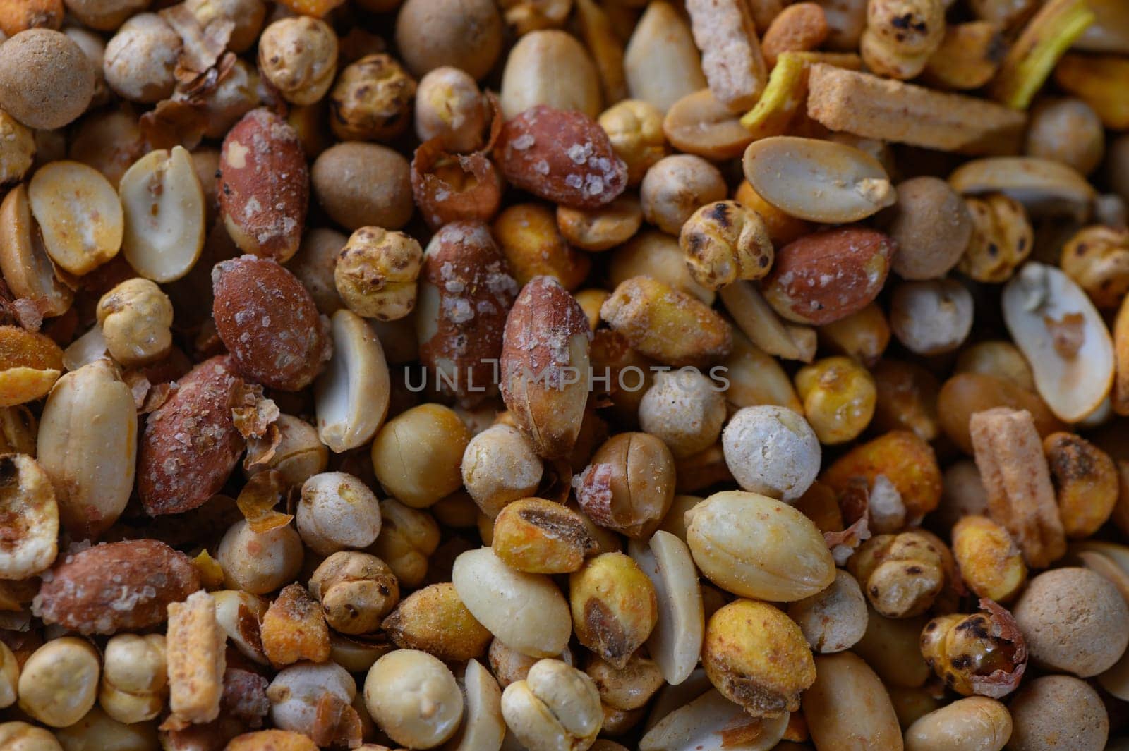 A vibrant display of various seeds and nuts lies on a rustic wooden table, showcasing nature's bounty at a market.