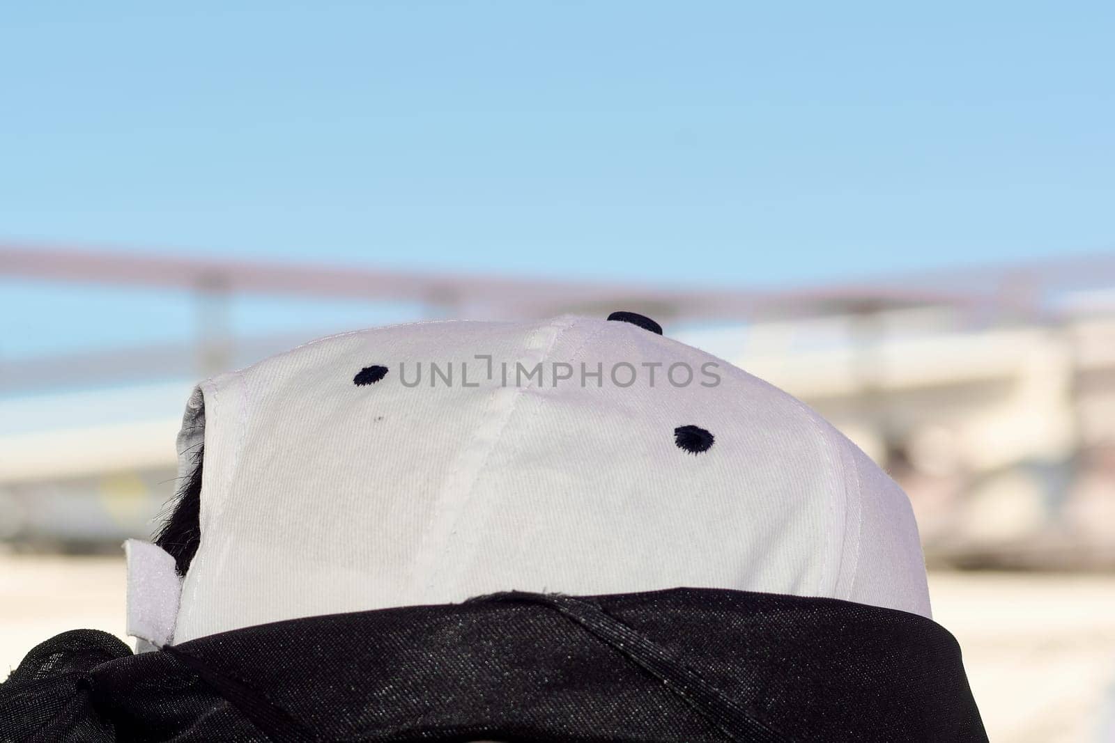 Minimalist design of a casual cap captured outdoors with soft focus on its texture and black ventilation, blending style and comfort.
