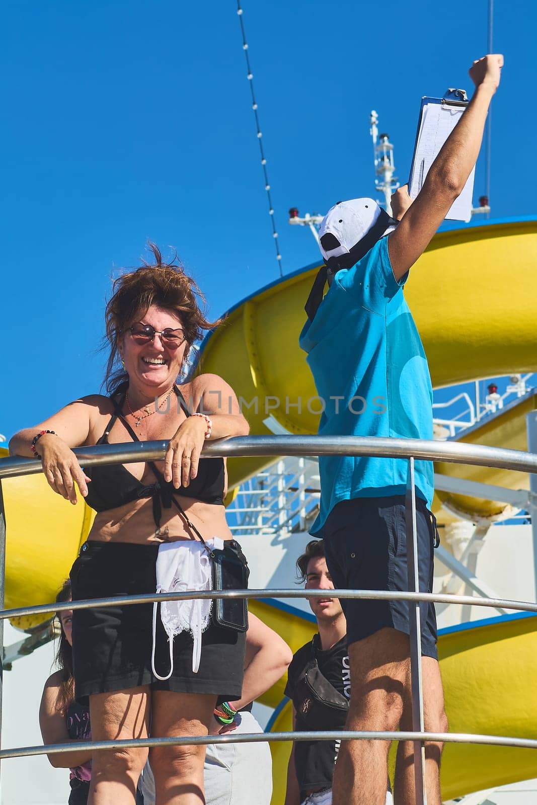 Catania. Italy - March 11, 2025: Close-up of a performer and guest sharing a cheerful moment during a lively onstage interaction, capturing their joyful expressions.
