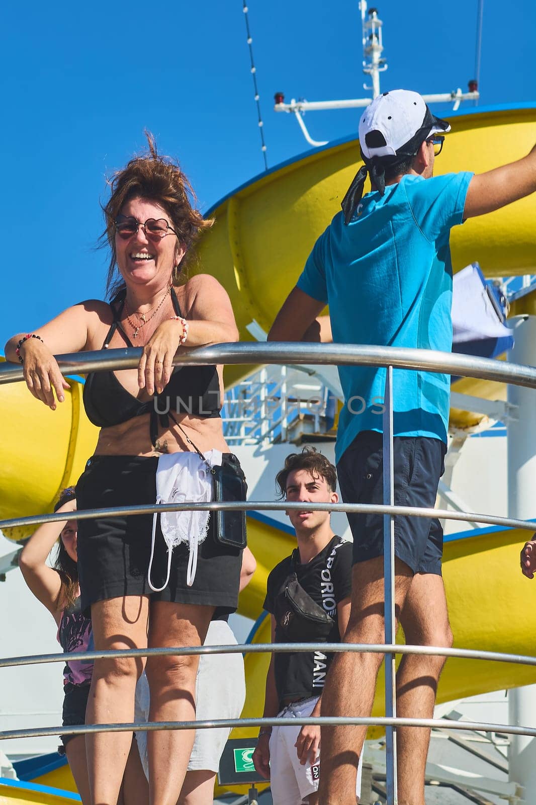 Catania. Italy - March 11, 2025: A male entertainer enthusiastically interacts with a smiling female guest on stage, showcasing vibrant energy and audience engagement.