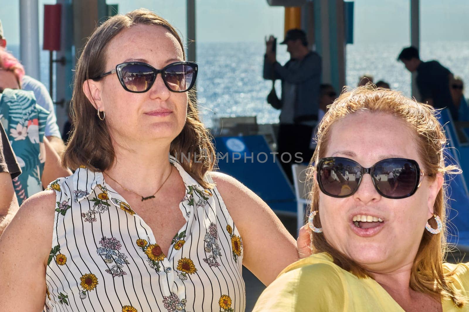 Catania. Italy - March 11, 2025: A group of people raising their hands during an outdoor activity, smiling and enjoying a vibrant social gathering under the sunny sky.