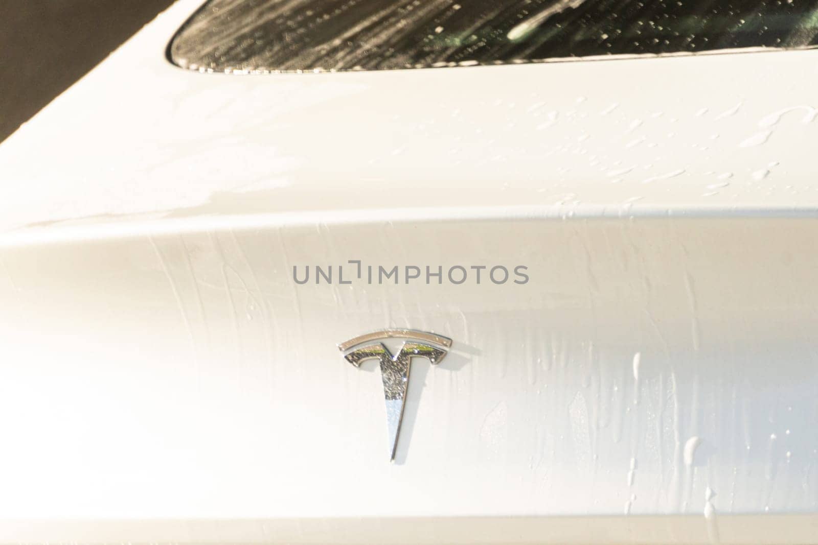 Denver, Colorado, USA-September 1, 2023-Efficiently cleaning an electric car in the comfort of a suburban driveway, combining eco-consciousness with practicality.