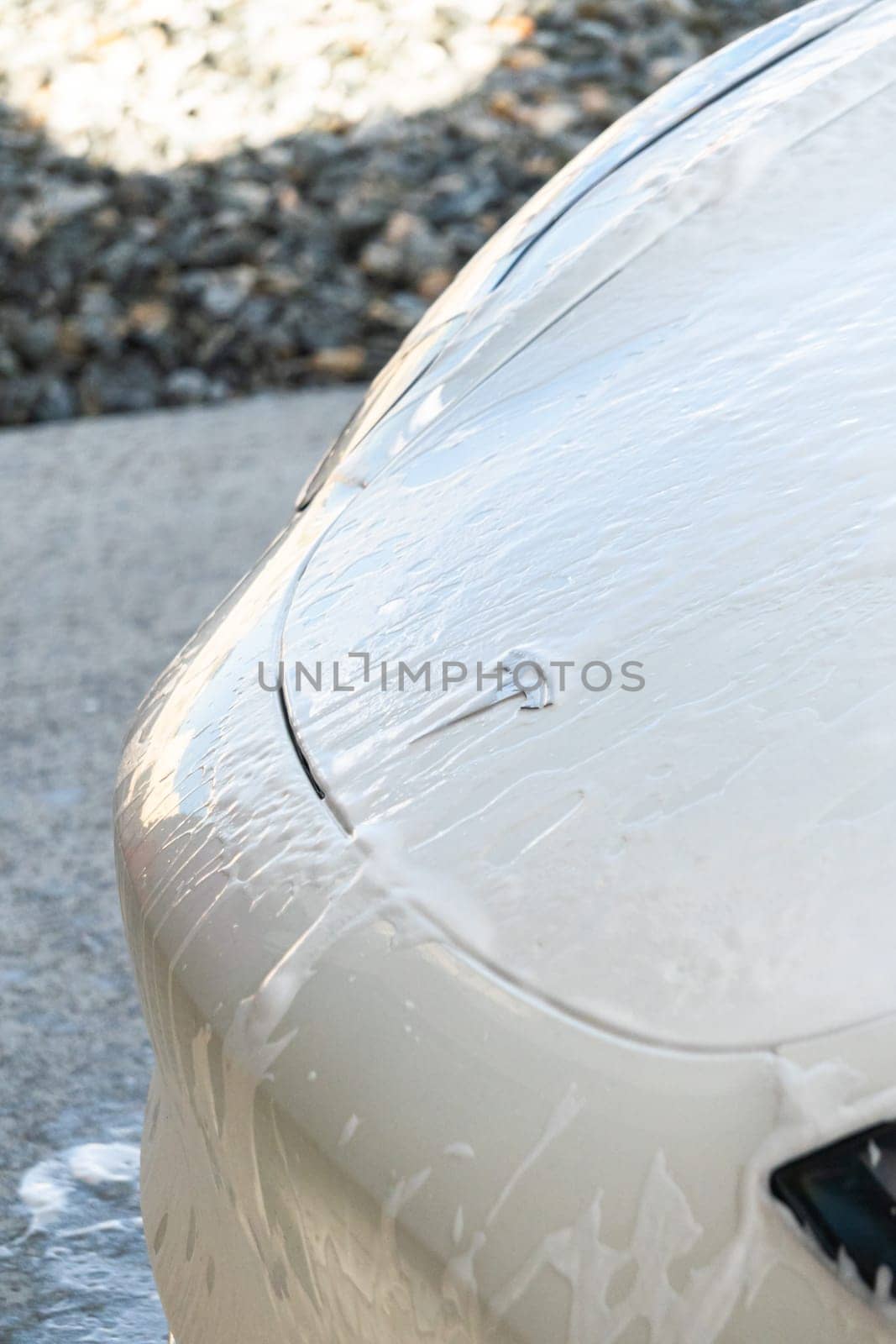 Denver, Colorado, USA-September 1, 2023-Efficiently cleaning an electric car in the comfort of a suburban driveway, combining eco-consciousness with practicality.