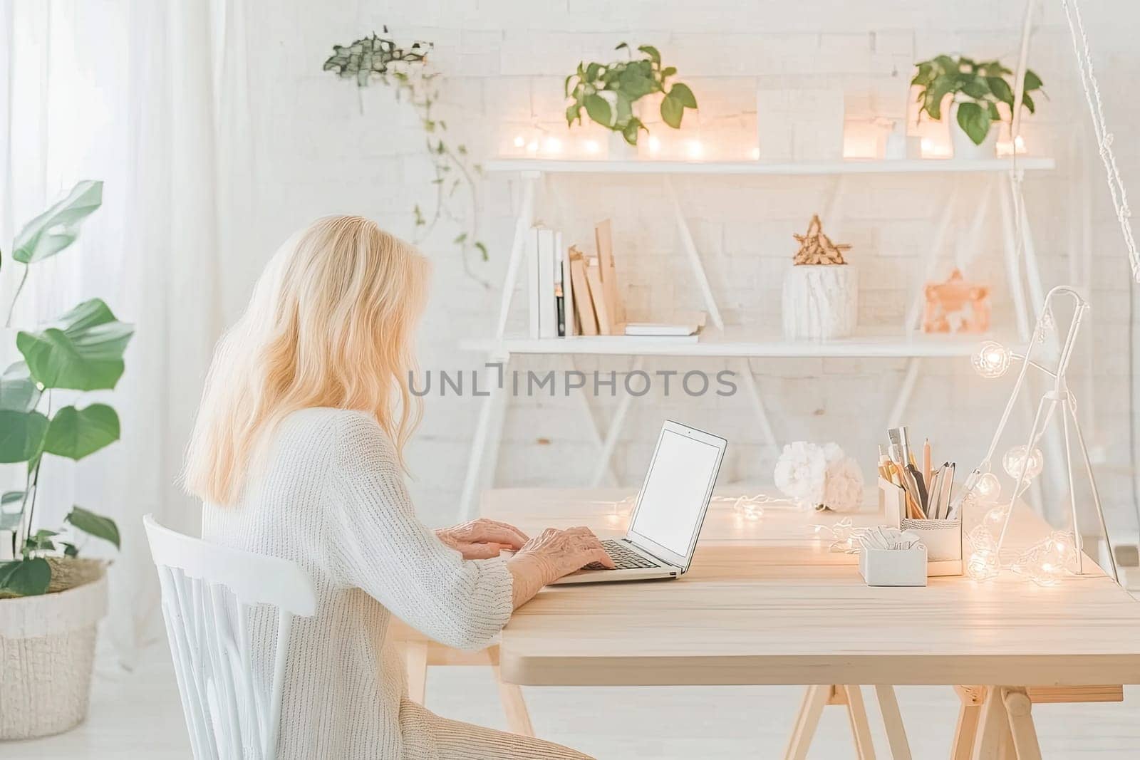 A woman sits at a wooden desk in a bright room, typing on a laptop. The space is adorned with plants and soft lights, creating a cozy and inviting atmosphere for productivity.