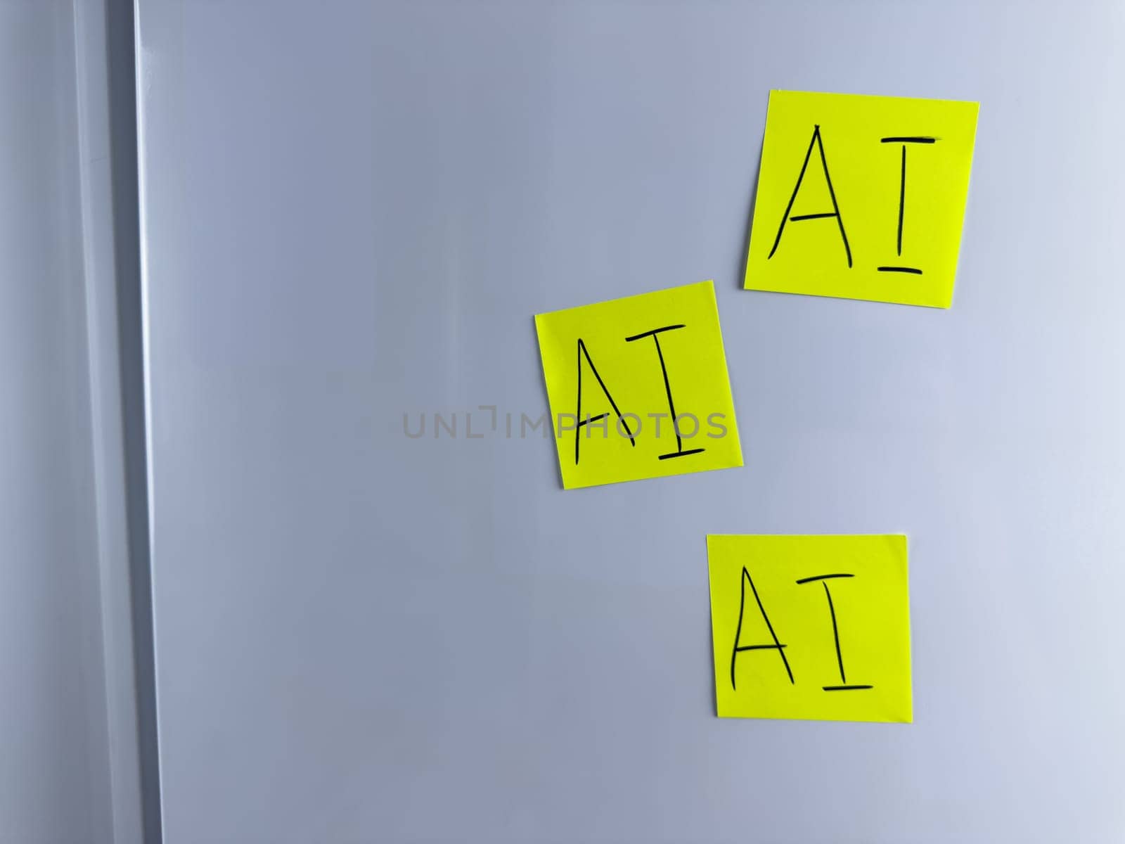 Note with the inscription AI. Colored stickers with the word artificial intelligence hang on white background for project about neural networks. Photo for simple background about modern technologies