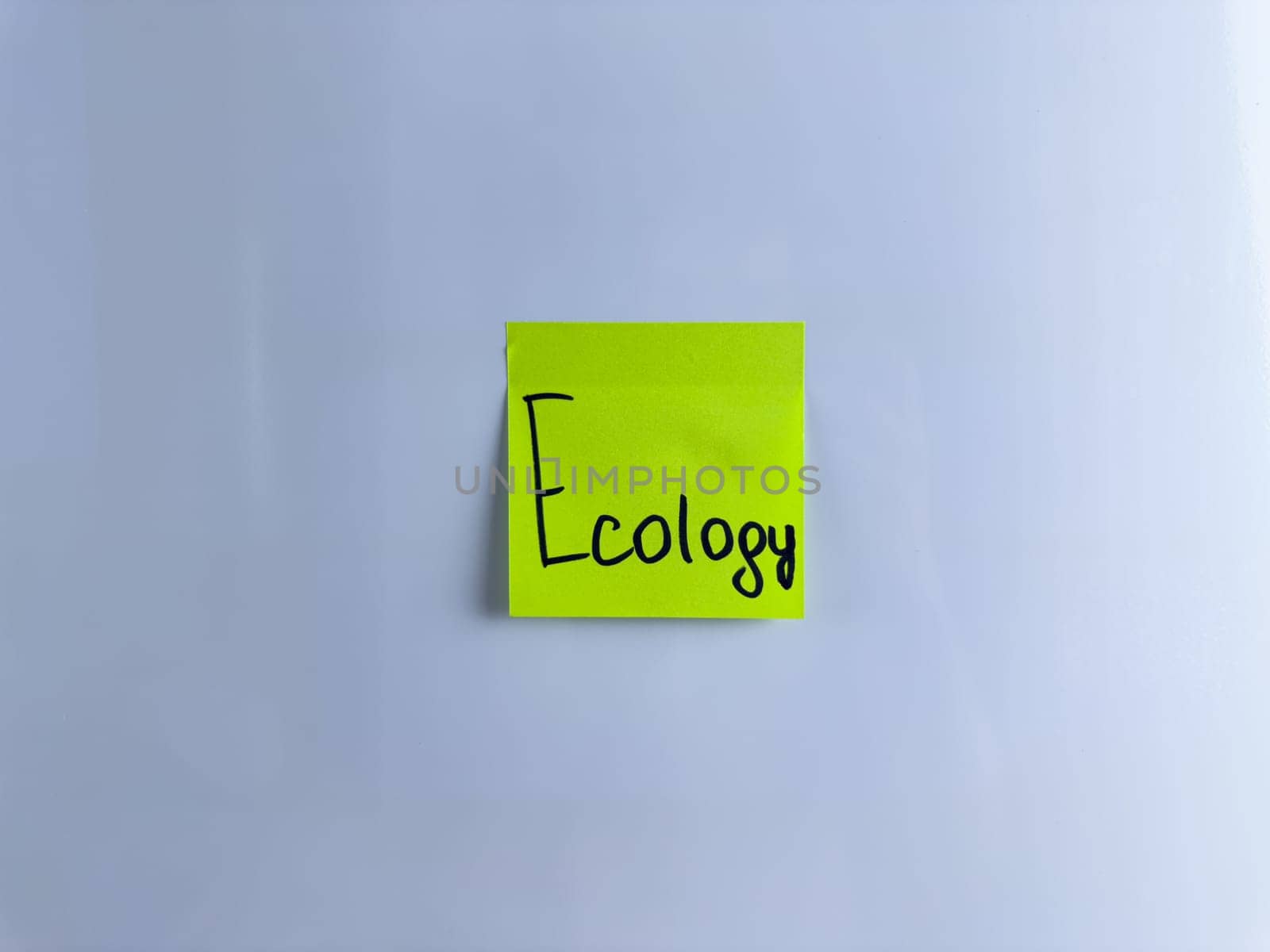 Conceptual photo about ecology with sticky note. The word ecology on white background to draw attention to environmental issues and care for animals and plants, green energy and ecology