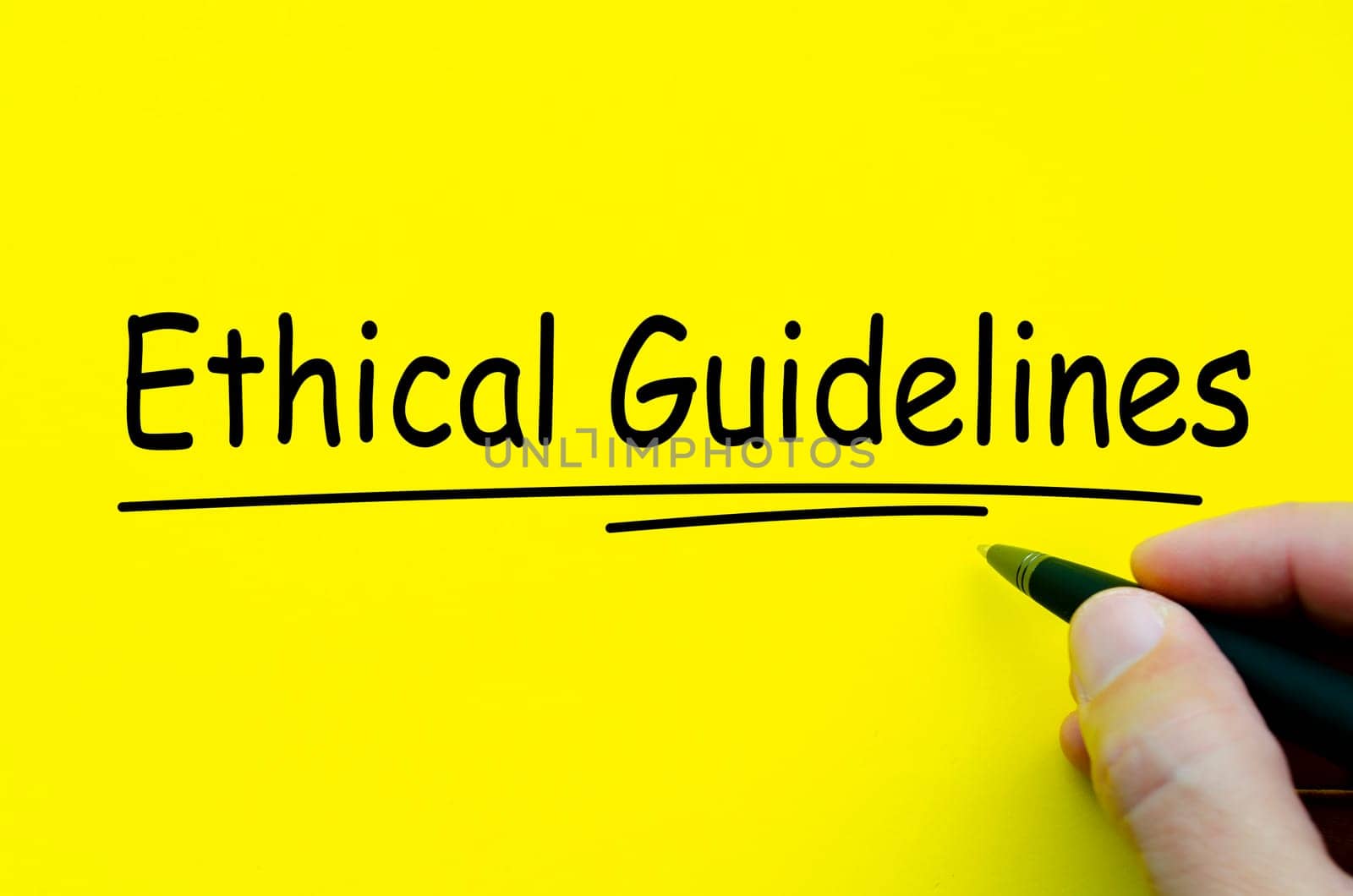 Hand written text about Ethical Guidelines on yellow notepad.