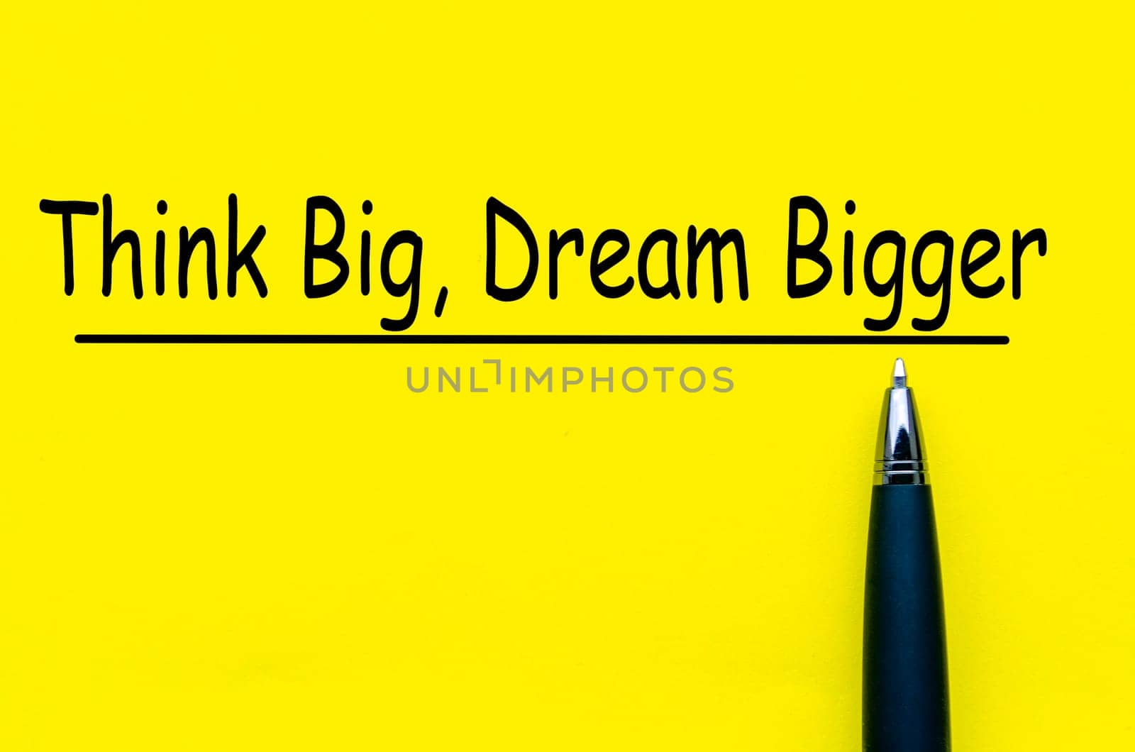 Think Big and Dream Bigger text on yellow cover background.