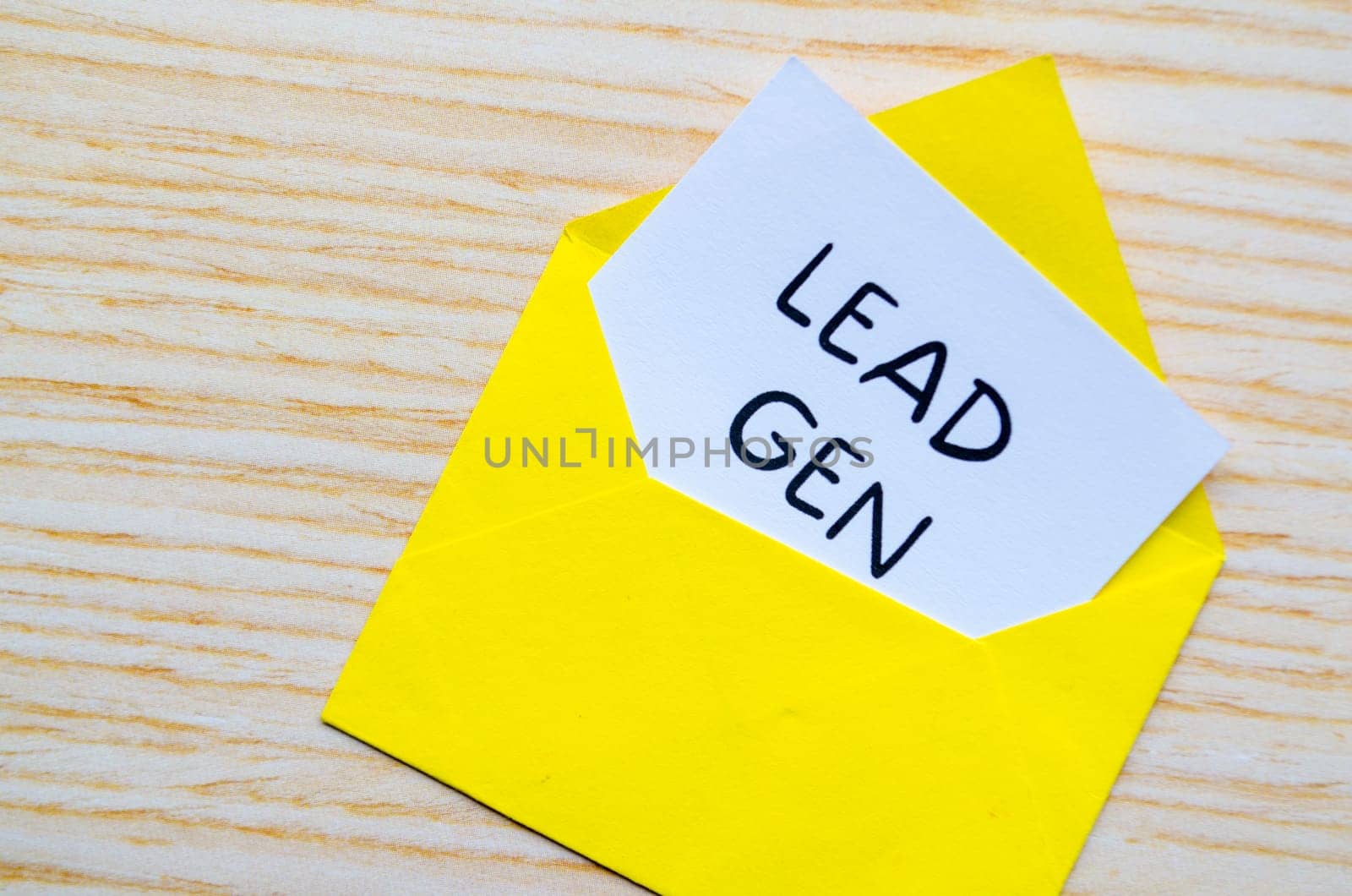 Lead Gen text on white notepad with yellow envelope. Online marketing concept.