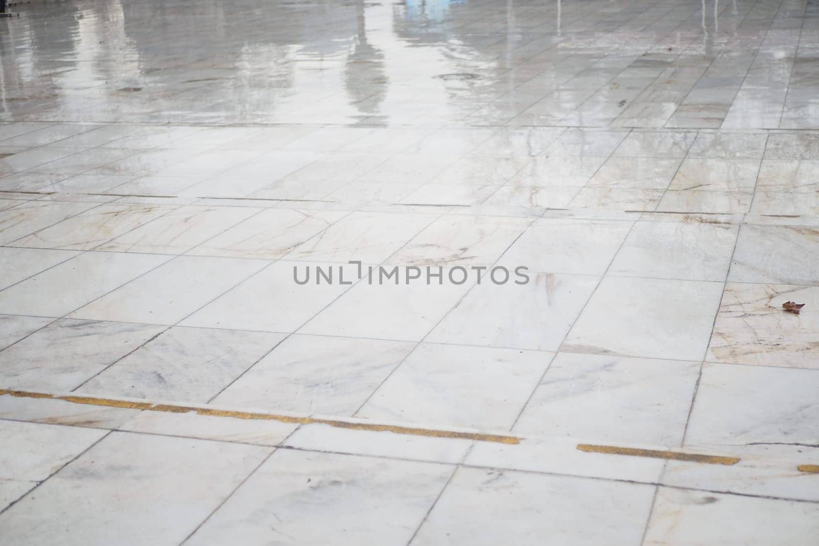 The polished marble floor glistens from recent cleaning, creating reflections.