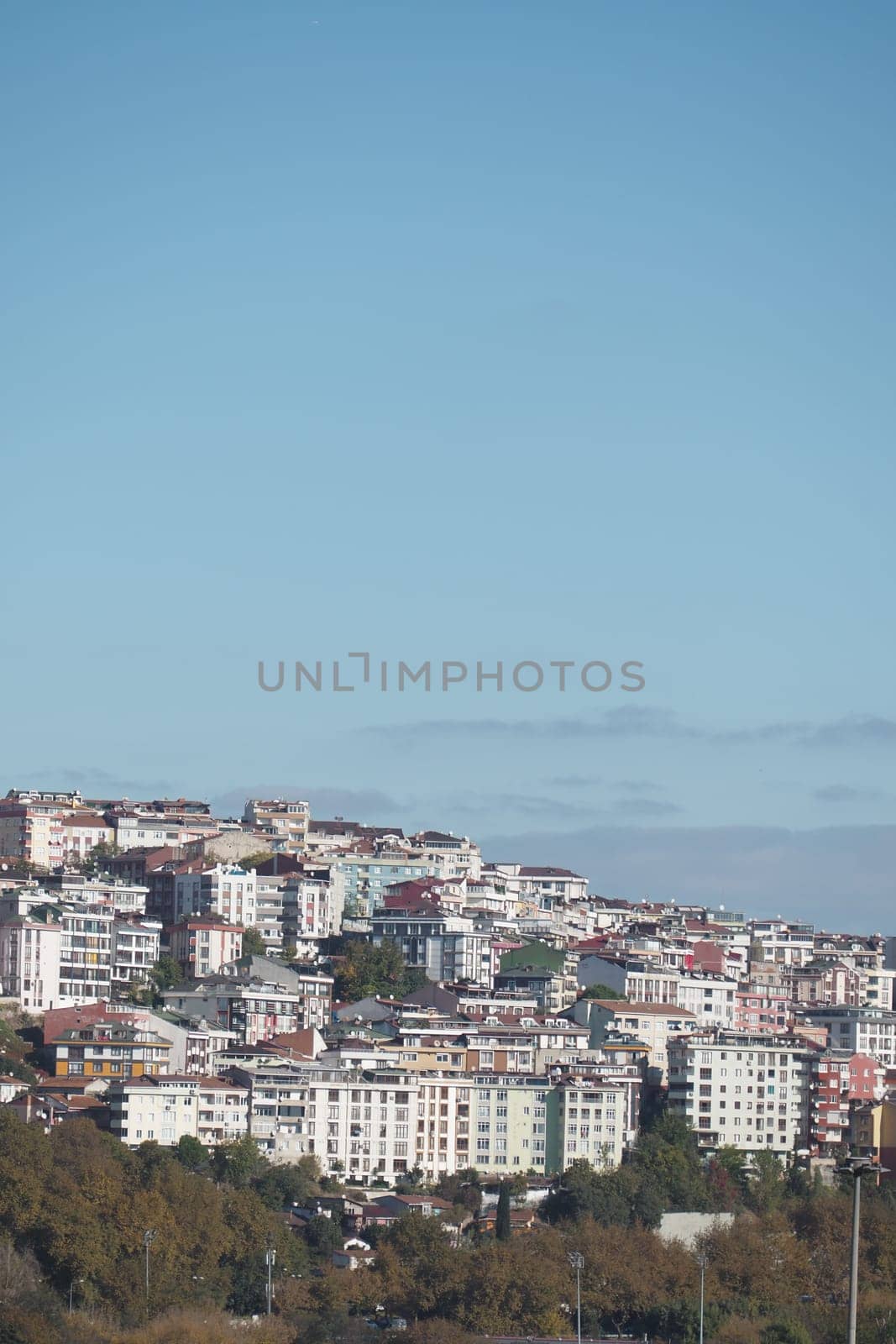 Vibrant residential buildings stacked on a hillside during a sunny day.