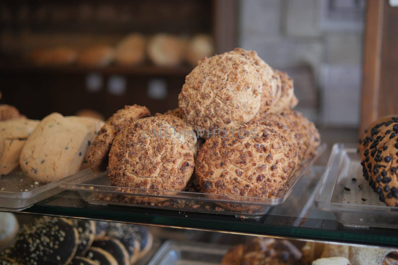 Assorted delicious cookies are showcased in a warm bakery setting.