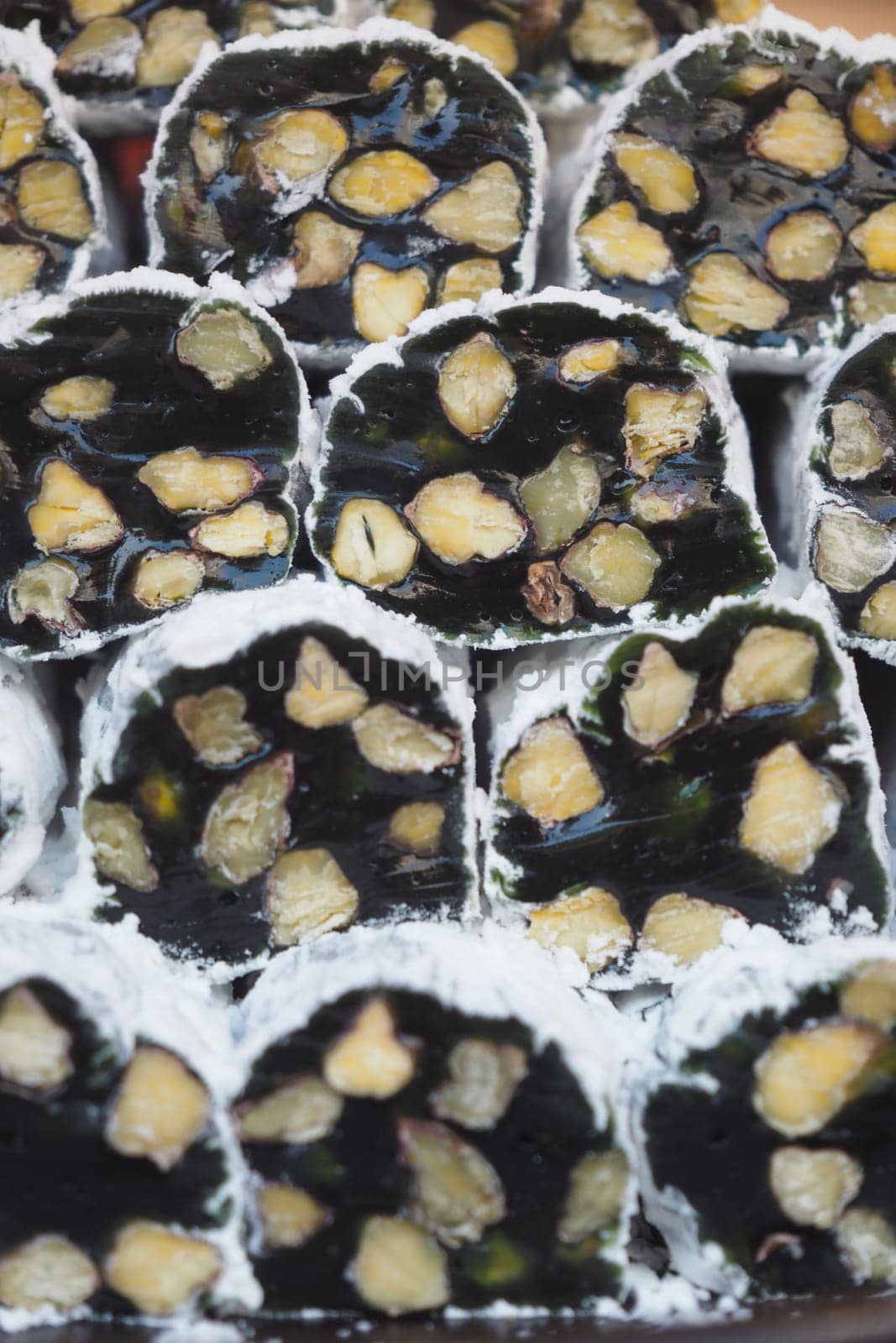 Delicious turkish dessert rolls filled with nuts .