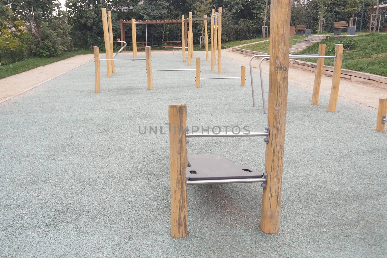 Empty outdoor fitness area features various workout stations for exercise.